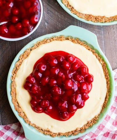 cream cheese pie with cherries on top.