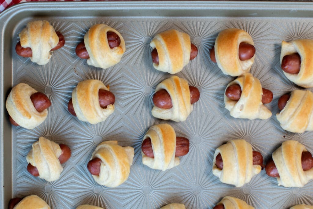 close up of pigs in a blanket on sheet pan
