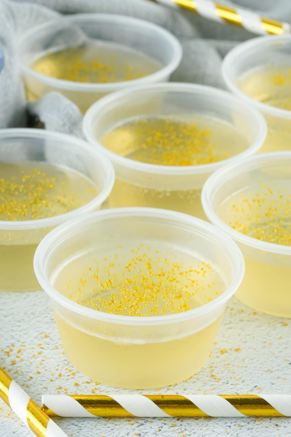 close up of champagne jello shots with gold sprinkles